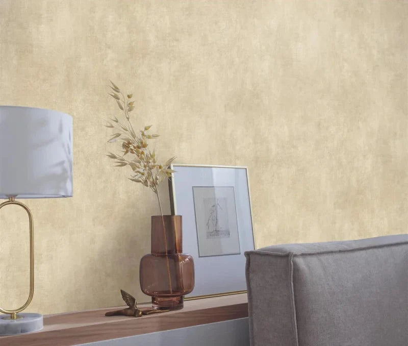 Erismann Elle Decoration 4 beige textured wallpaper with soft plaster-like finish behind a shelf and lamp