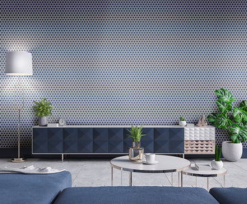 Modern living room with geometric wallpaper, blue sofa, and decorative elements.