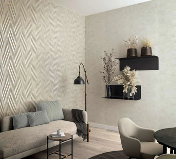 Marburg City Glow 34265 Feature wall with beige textured wallpaper of raised vertical waves in a living room, shown with a sofa, floor lamp, floating shelves holding vases with dried stems, a small round side table, and an armchair.