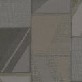 Textured fabric pattern with geometric shapes in shades of gray and brown.
