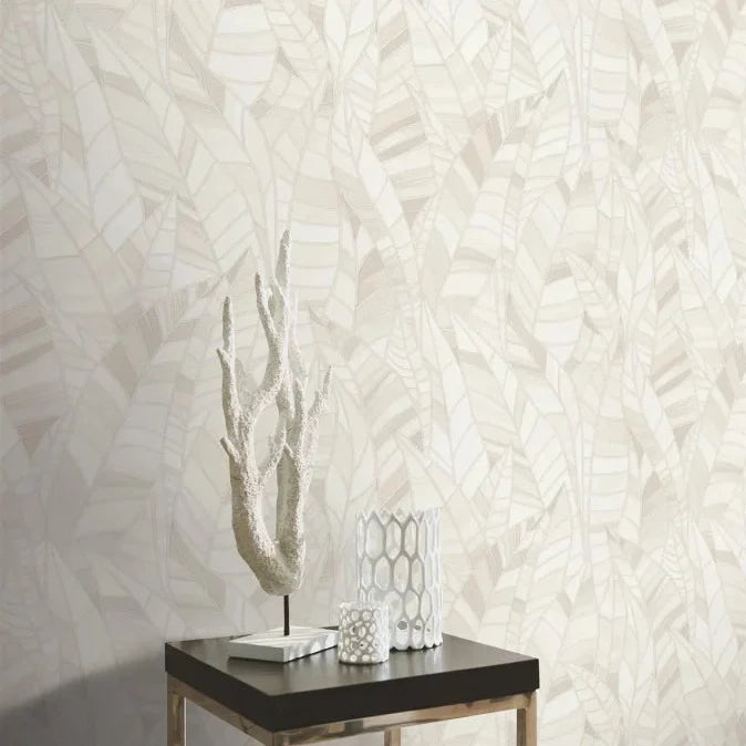 Erismann Elle Decoration 4 cream botanical wallpaper with subtle leaf pattern and textured finish behind a side table and statue