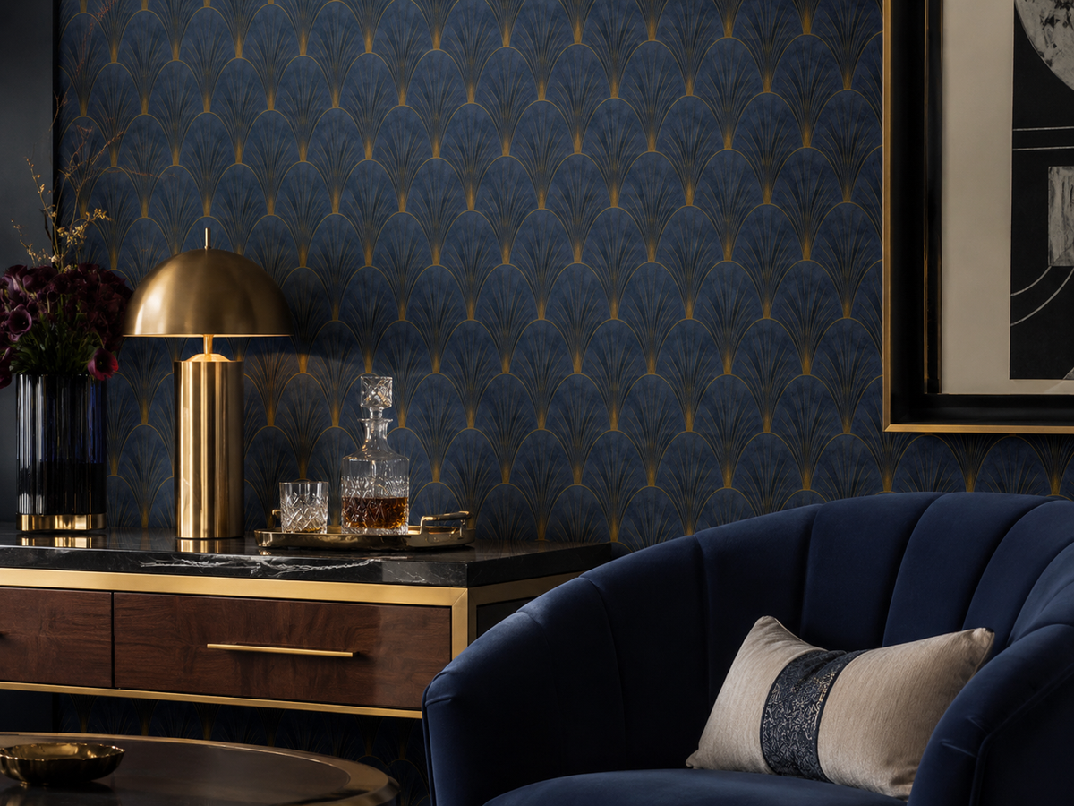 Erismann Elle Decoration Art Deco fan wallpaper in deep navy and gold tones in luxurious lounge with a blue chair and a wooden metallic sideboard