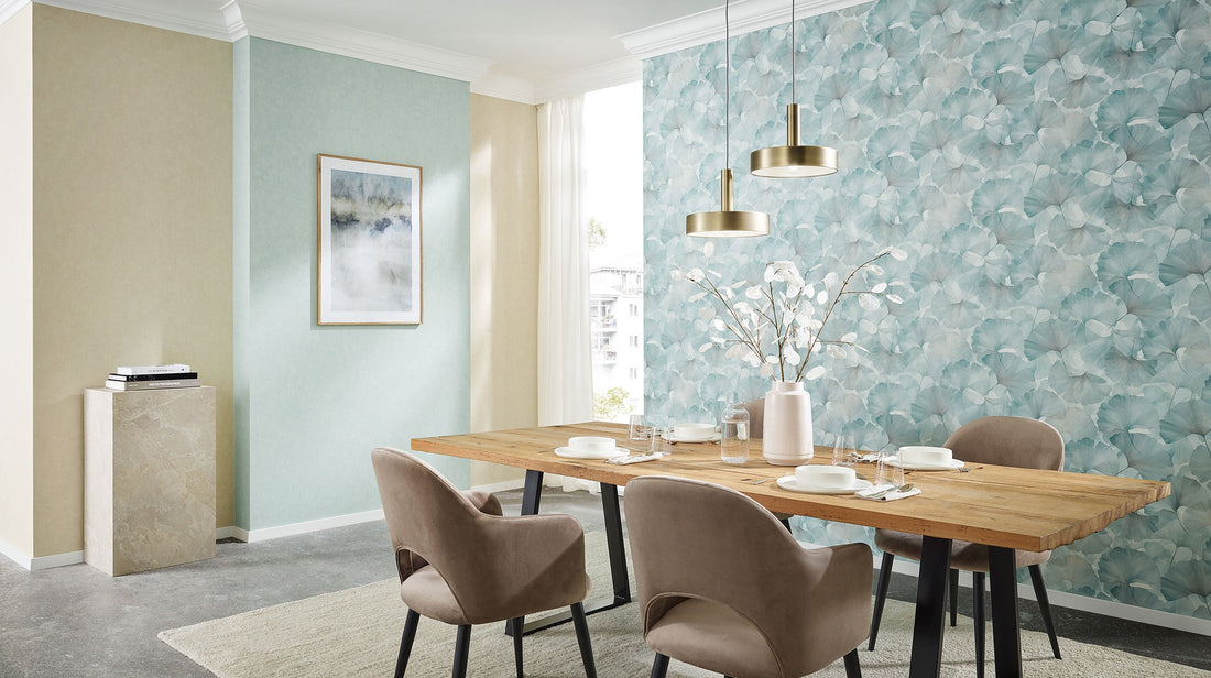 Erismann Elysium botanical wallpaper featuring delicate ginkgo leaves in soft sage green tones layered over a light neutral background, creating a fresh, airy and calming natural aesthetic.