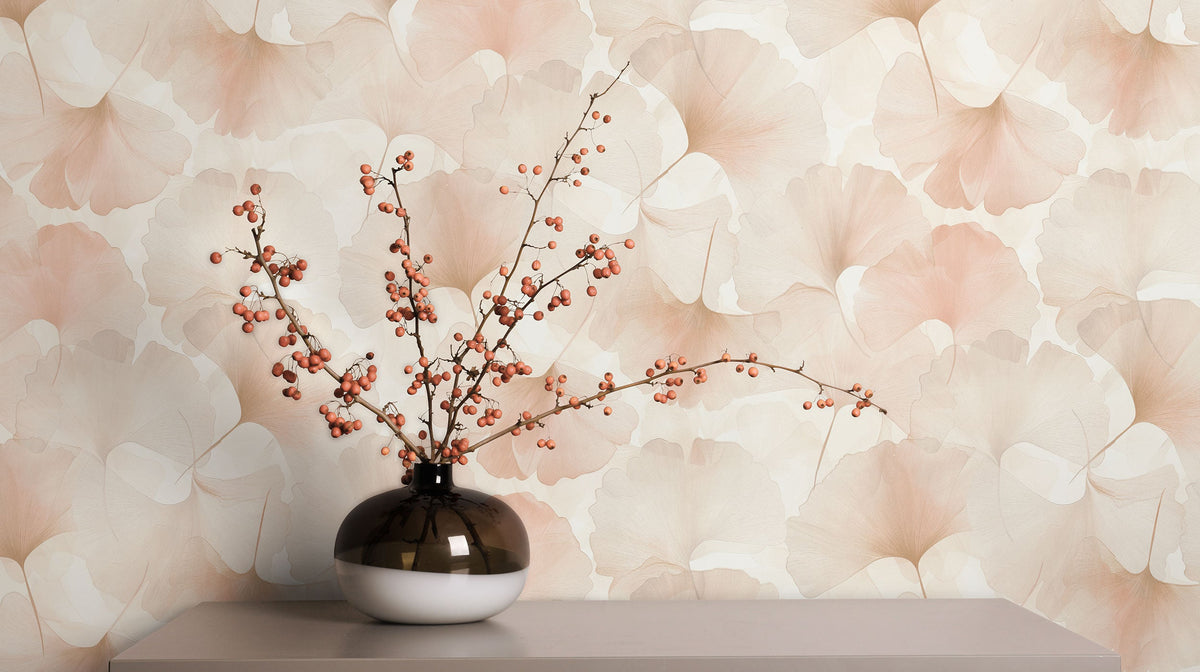 Erismann Elysium 10470-05 pink and beige ginkgo leaf wallpaper on a feature wall styled with a vase and flowering branches.