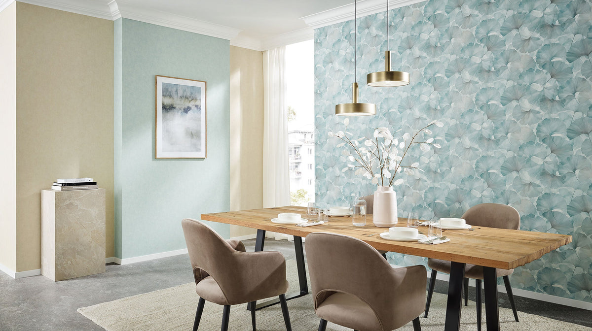 Erismann Elysium 10470-18 blue and white ginkgo leaf wallpaper on a dining-room feature wall with a light wood table and chairs.