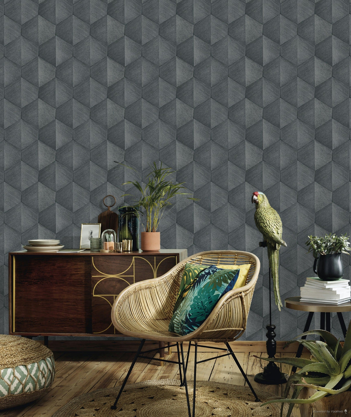 Erismann Fashion For Walls 4 10370-10 wallpaper lounge feature wall with a grey 3D geometric pattern behind a rattan chair with patterned cushions, a wooden sideboard, potted plants, and a relaxed tropical vibe.
