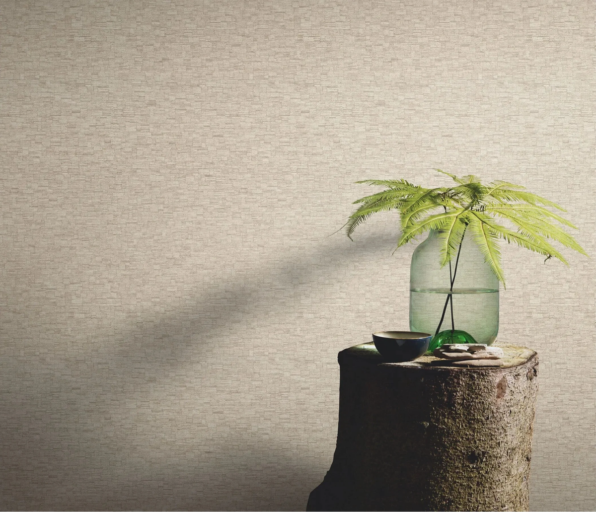 Erismann Forest Dreams 10562-32 wallpaper on a textured wall behind a tree stump table with glass vase and fern stems.