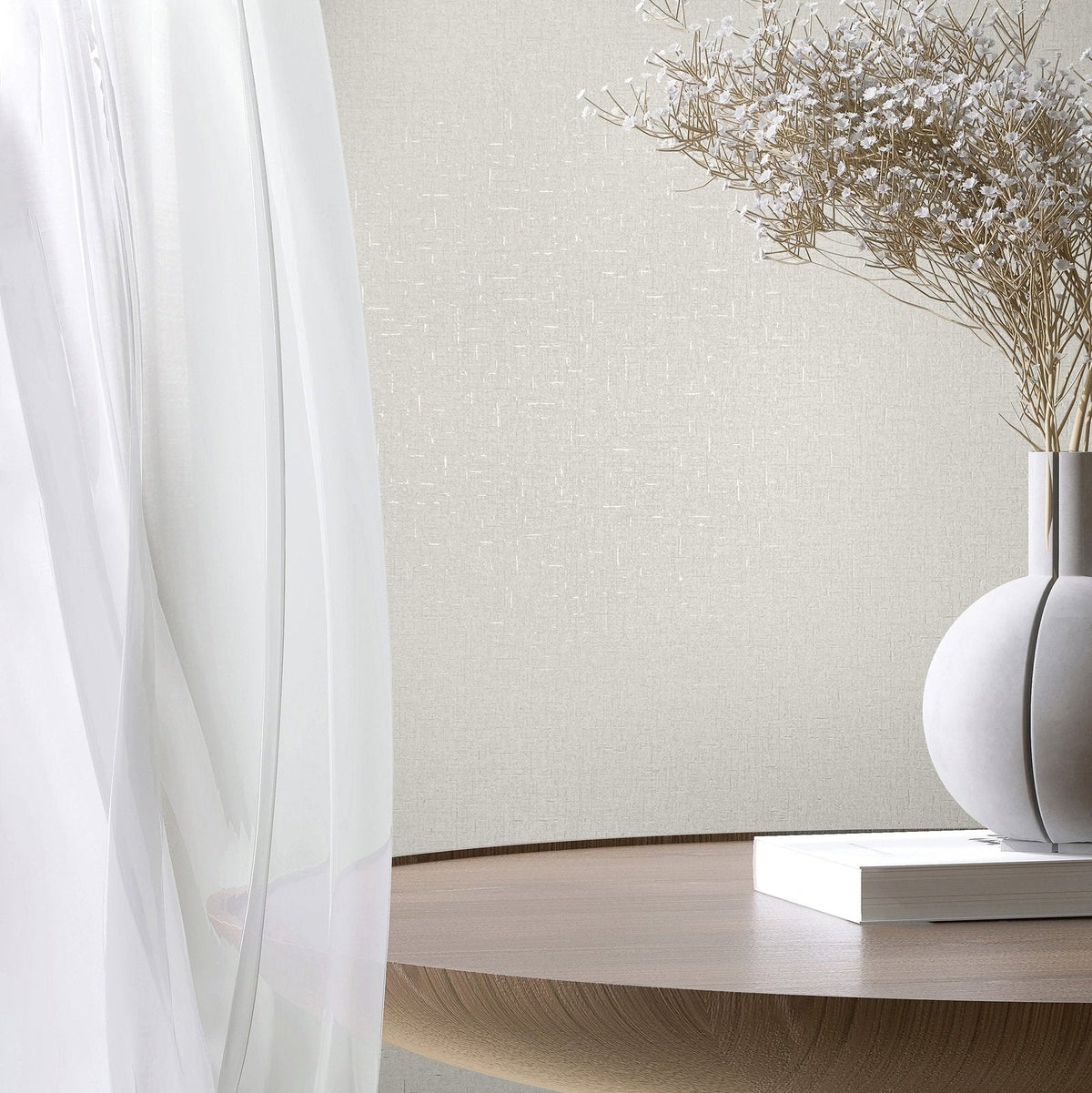 Marburg City Romance 35115 White textured wallpaper with a subtle crosshatch look behind a sheer curtain, a round wooden table, a spherical vase holding dried stems, and a closed book.
