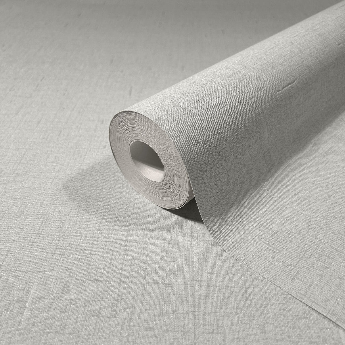 Marburg City Romance 35116 Close-up of a light gray textured wallpaper roll resting on the same pattern, showing a fine crosshatch surface.