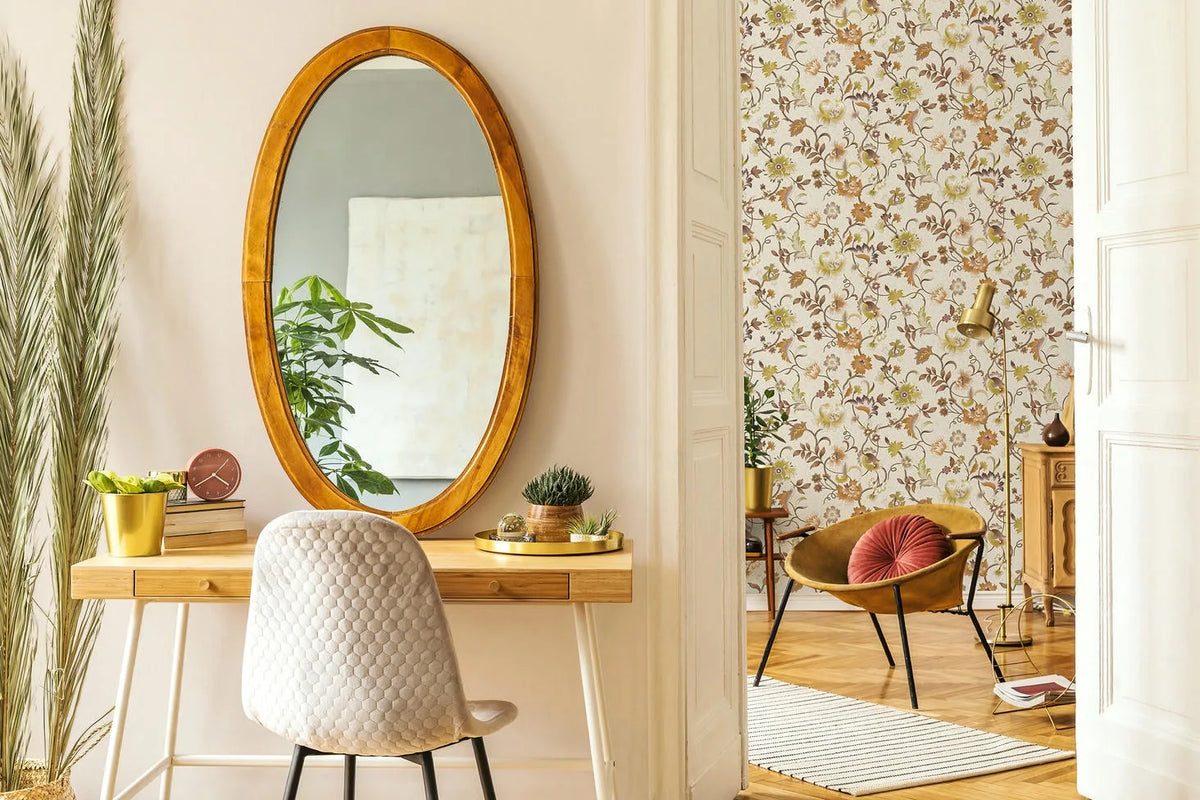 Marburg 47607 wallpaper on a lounge feature wall with an accent chair and round cushion, metal floor lamp, wooden sideboard, small plant on a stand, and a striped rug, warm and relaxed.