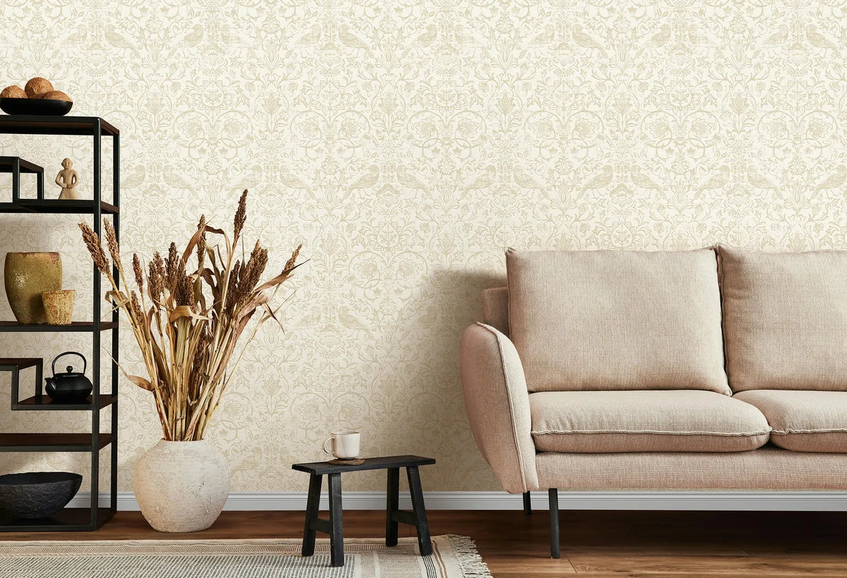 Marburg 47625 wallpaper for a lounge feature wall behind a cushioned sofa, open shelving with ceramics, a floor vase of dried grasses, and a low stool table, creating a calm minimalist mood.
