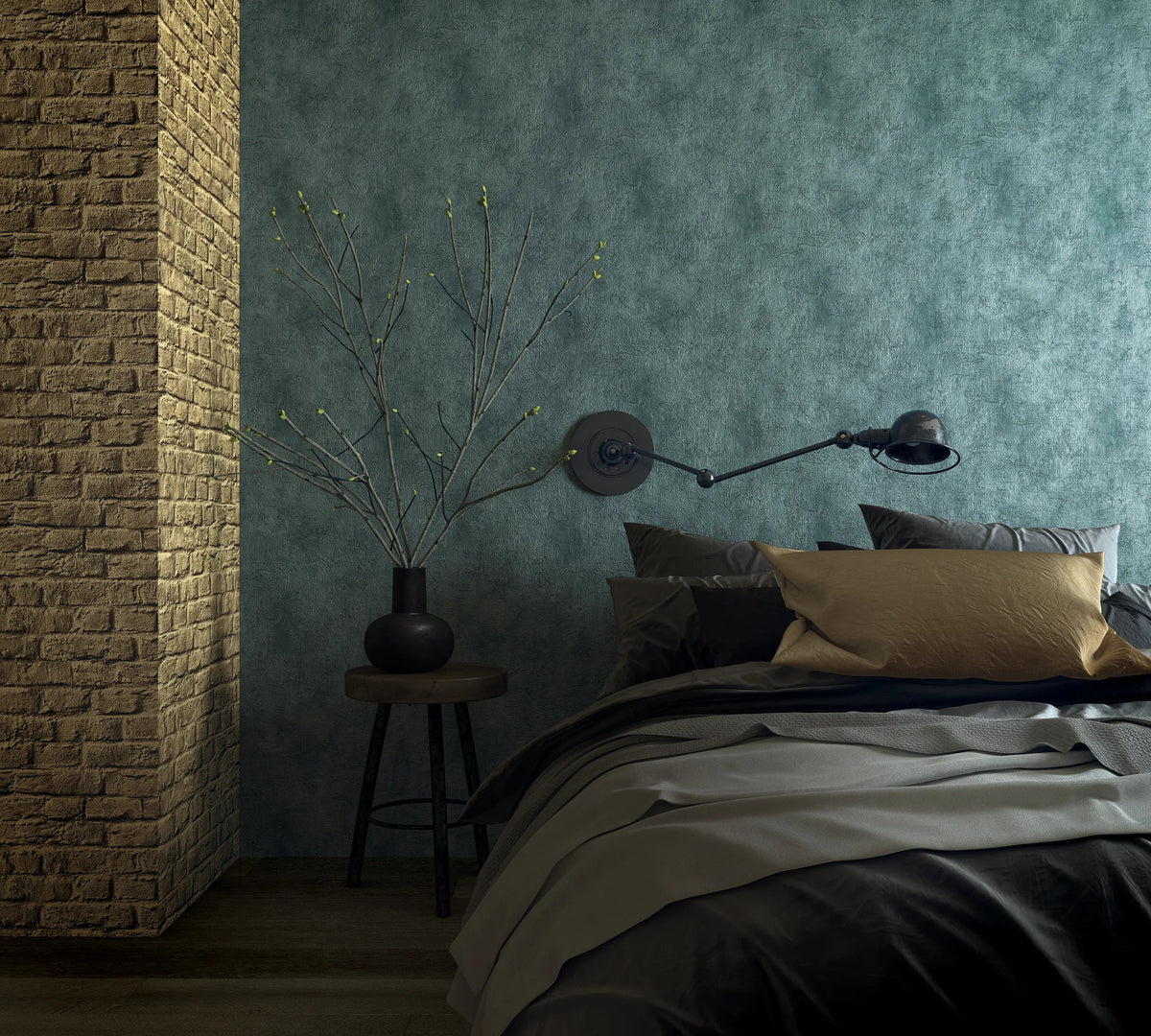 Marburg Loft Superior 34189 Bedroom scene featuring a green mottled textured wallpaper behind a bed, a black swing-arm wall lamp, a brick column, and a small round stool with a black vase holding bare branches.