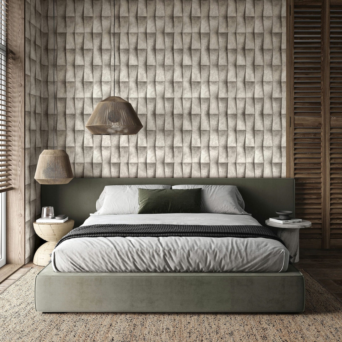 Marburg Novamur Mona 81650 Bedroom scene with a bed and twin pendant lights; the feature wall is covered in beige and grey geometric wallpaper that creates a folded 3D effect. Side tables, window blinds, and a textured rug are visible.