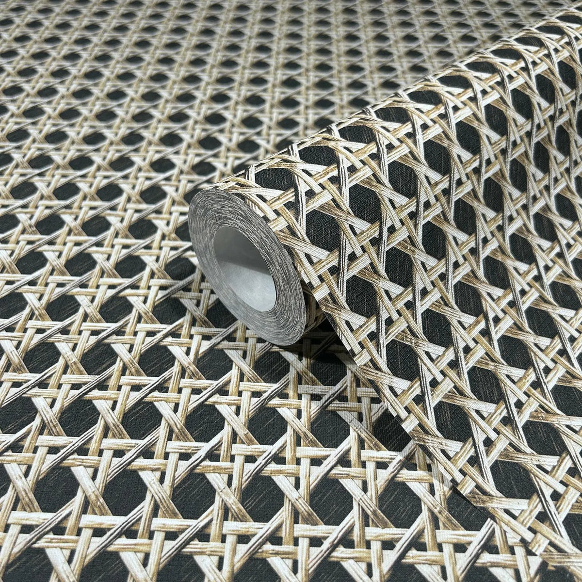 Marburg Struktura 45751 Close-up of a wallpaper roll featuring a beige and brown woven cane lattice pattern on a dark background, displayed on an unrolled sheet of the same design.